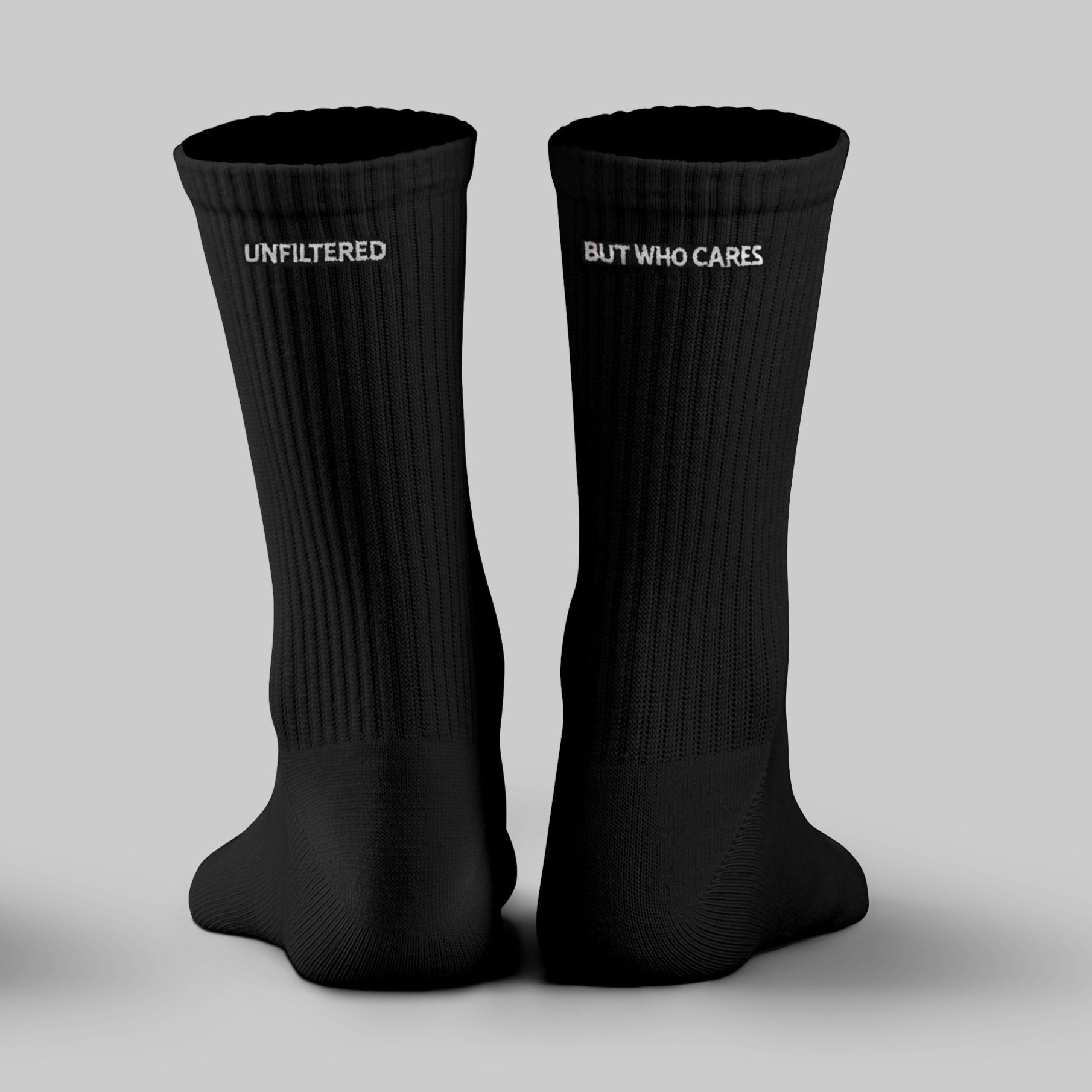 Two pairs of white and black socks with text on a grey background cheeky socks novelty sock gifts UK
